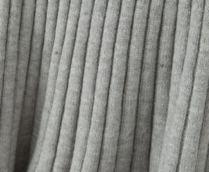 Macro detail of soft light grey ribbed knit fabric texture with fine fiber finish