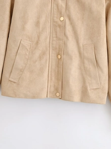 Detailed close-up of light brown faux suede jacket with silver metallic snap buttons