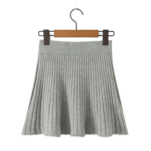 Detailed view of the gray knitted pleated mini skirt with elastic high waistband