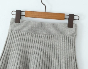 Close-up of gray ribbed knit texture and elastic waistband on a stylish skirt