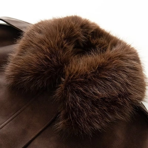 Detailed close-up of premium faux suede texture and fluffy faux fur collar on the jacket