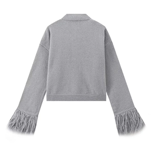 Detail of grey knit cardigan back with luxurious feather trim on the sleeve cuffs
