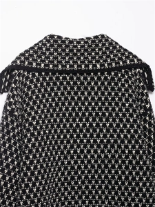 Detail of knit sweater with black and white geometric pattern and large collar