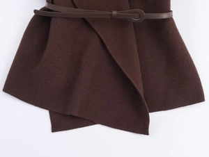 Detail of dark brown knit texture and slim leather belt with oval buckle on cardigan
