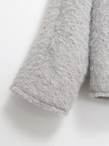 Close-up of thick light gray teddy fleece sleeve showing soft curly fiber texture