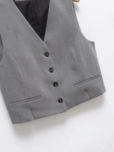 Detail of grey V-neck waistcoat with four buttons and textured twill fabric on hanger