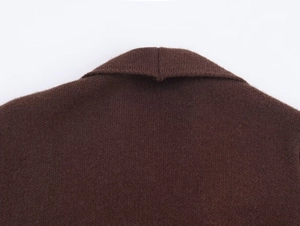 Macro detail of dark brown knitted collar with premium textured wool blend finish