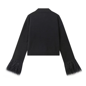 Detail view of the black knit cardigan back with luxurious faux fur trim on the cuffs