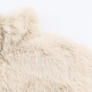 Macro detail of high-quality cream faux fur jacket with soft texture and plush pile