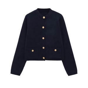 Detailed close-up of navy knit cardigan featuring gold embossed buttons and waffle texture