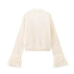 Back view of cream knit sweater featuring elegant long fringe detail on the cuffs