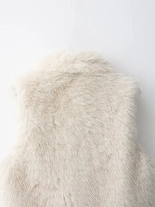 Close-up of fluffy faux fur texture on a cream-colored stand collar vest for women