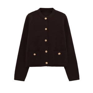Detail of dark brown knit cardigan with golden embossed buttons and textured patch pockets
