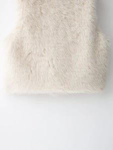 Close-up detail of soft faux fur texture on the cream sleeveless winter vest for women