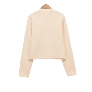 Detailed back view of cream white knit cardigan with soft texture and crew neckline