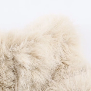Macro detail of plush faux fur texture on the off-white faux fur jacket collar
