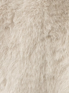 Close-up of soft beige faux fur texture showing dense and fluffy synthetic fibers