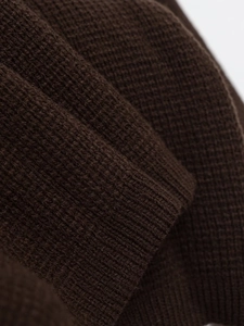 Close-up of dark coffee knit cardigan showing thick ribbed cuffs and soft texture