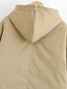 Primer plano de la espalda de una chaqueta caqui con capucha y detalle de cremallera dorada