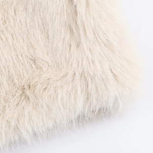 Close-up of the fluffy cream faux fur material on the stylish stand collar jacket