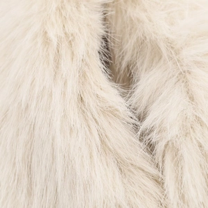 Macro shot of ivory faux fur texture showing soft high-density long plush fibers