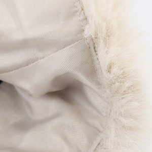 Close-up of the smooth twill lining and fluffy faux fur trim on this beige winter jacket