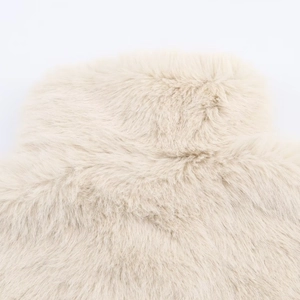 Detailed view of plush cream faux fur material on the collar of a winter jacket