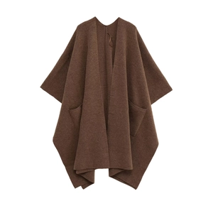 Détail de la maille marron douce et des poches plaquées de ce poncho élégant pour femme