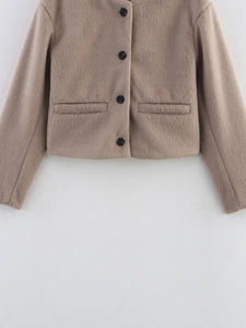 Detailed texture of khaki faux fur jacket featuring round neck and black buttons