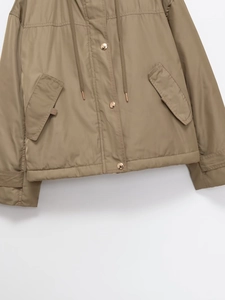 Detail of khaki hooded jacket with gold snap buttons and functional side pockets