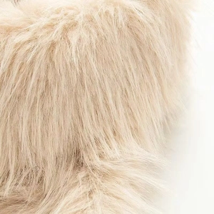Close-up of fluffy cream faux fur material with soft texture for winter jacket coats
