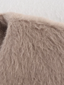 Detailed macro view of soft camel faux fur fabric texture with long dense fibers