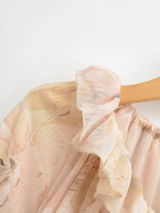 Detail of floral chiffon fabric featuring elegant ruffles and fine pleated texture
