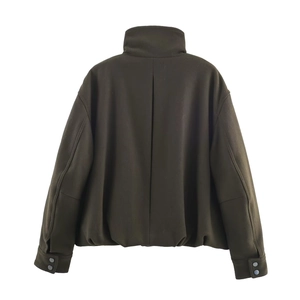 Detail view of the back of olive green jacket with drop shoulders and pleat design