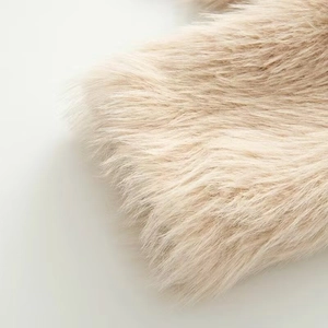 Close-up of soft cream faux fur texture on the collar of a long sleeve baseball jacket