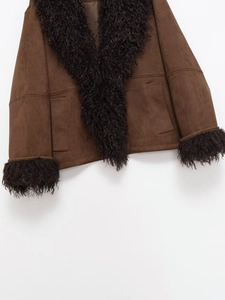 Detailed view of dark brown suede jacket with black faux fur collar and pocket details