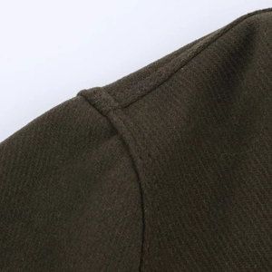 Detail shot of heavy olive green wool blend fabric with professional shoulder seam stitching