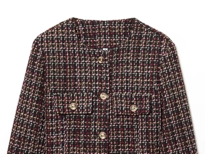 Detailed close-up of textured tweed jacket fabric with round neck and golden buttons