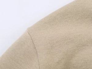 Detail of the high-quality stitching and khaki knitted fabric on shoulder seams