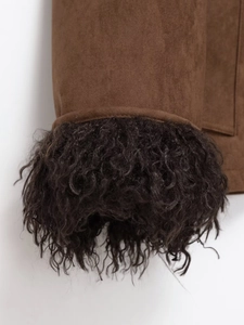 Detail of faux suede jacket showing high-quality black curly fur trim and fabric texture