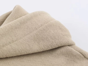 Close-up showing the soft texture and high-density knit of the beige hoodie set fabric