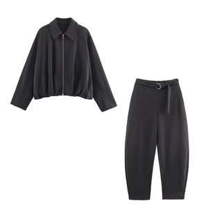 Detail of grey bomber jacket and high-waist trousers set with metal buckle belt