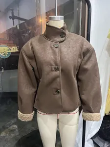 Detail of vintage brown faux leather jacket showing stand collar and cozy fleece lining