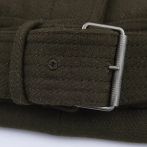 Detailed close-up of dark olive wool jacket belt with silver metal needle buckle and stitching