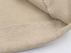 Detailed macro view of the high-density knit ribbed cuffs and stitching on the tracksuit