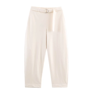 Detailed view of high-waisted cream trousers with matching D-ring belt and tapered cuffs