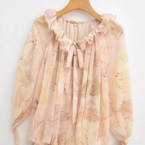 Elegant apricot floral chiffon blouse with ruffled neckline and delicate tie detailing