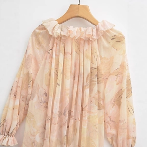 Floral ink-wash print blouse with ruffle neckline and pleated texture on hanger