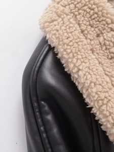 Close-up of black PU leather jacket with premium beige faux shearling lining details