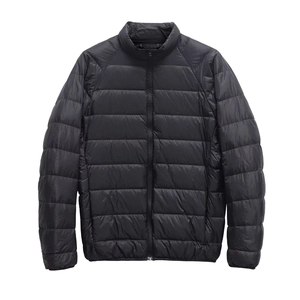 Close-up of black quilted puffer jacket with standing collar and durable zipper